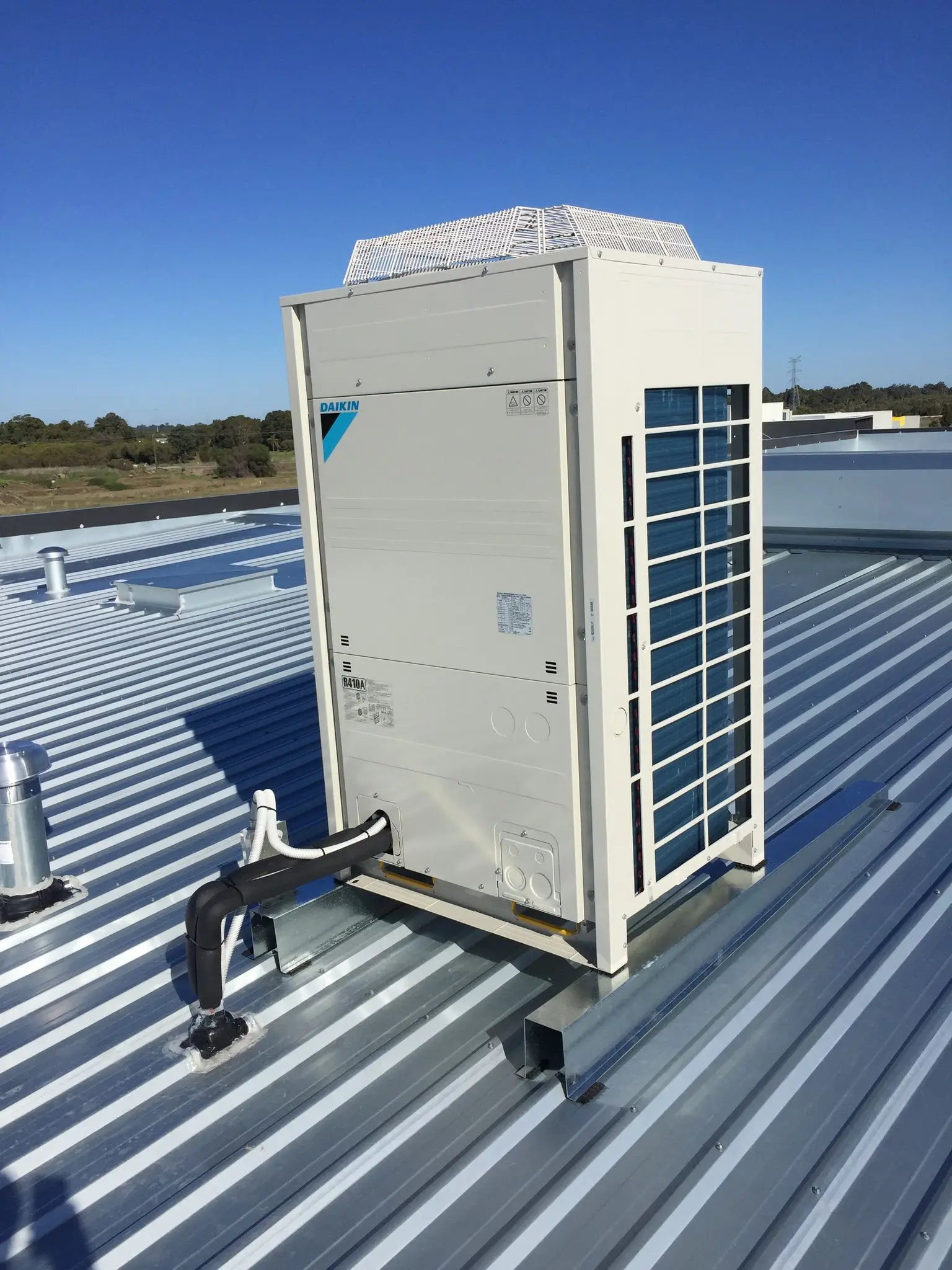 Daikin commercial condensing unit installed on a Colorbond roof